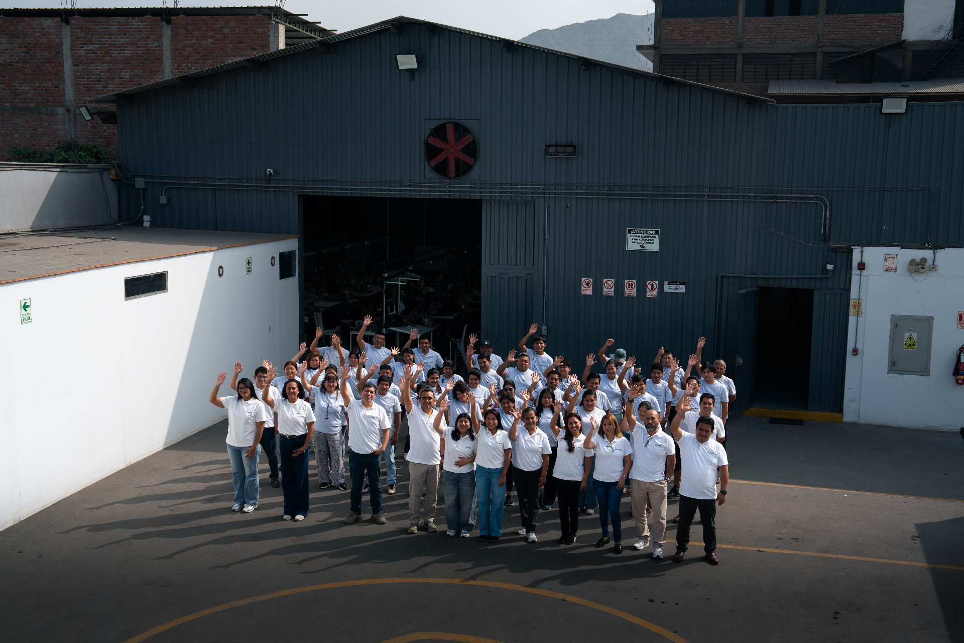 The Prospera team gathered outside the factory in Lima, Peru