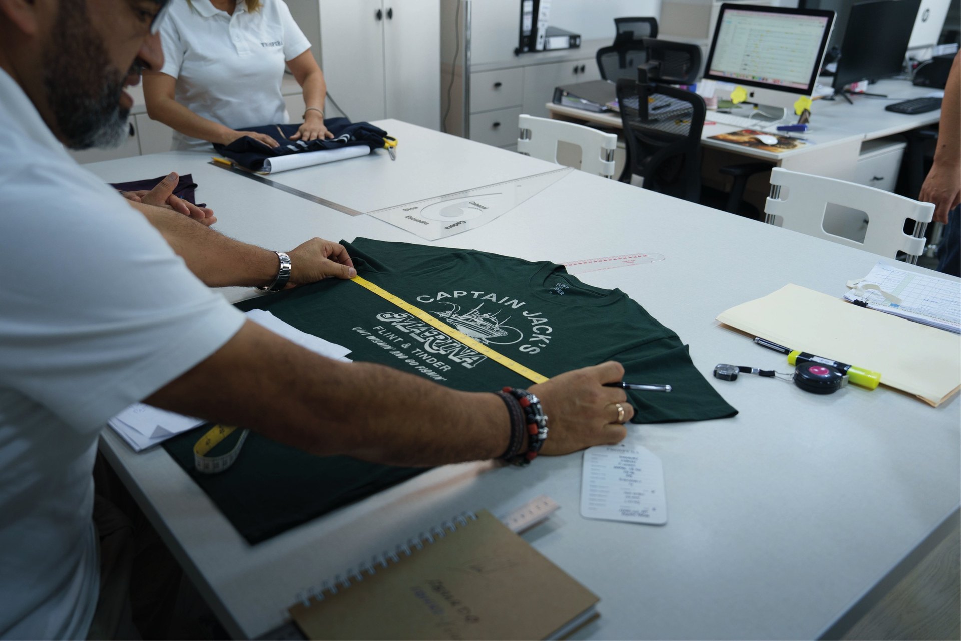 Prospera technician measuring a garment at a quality control station