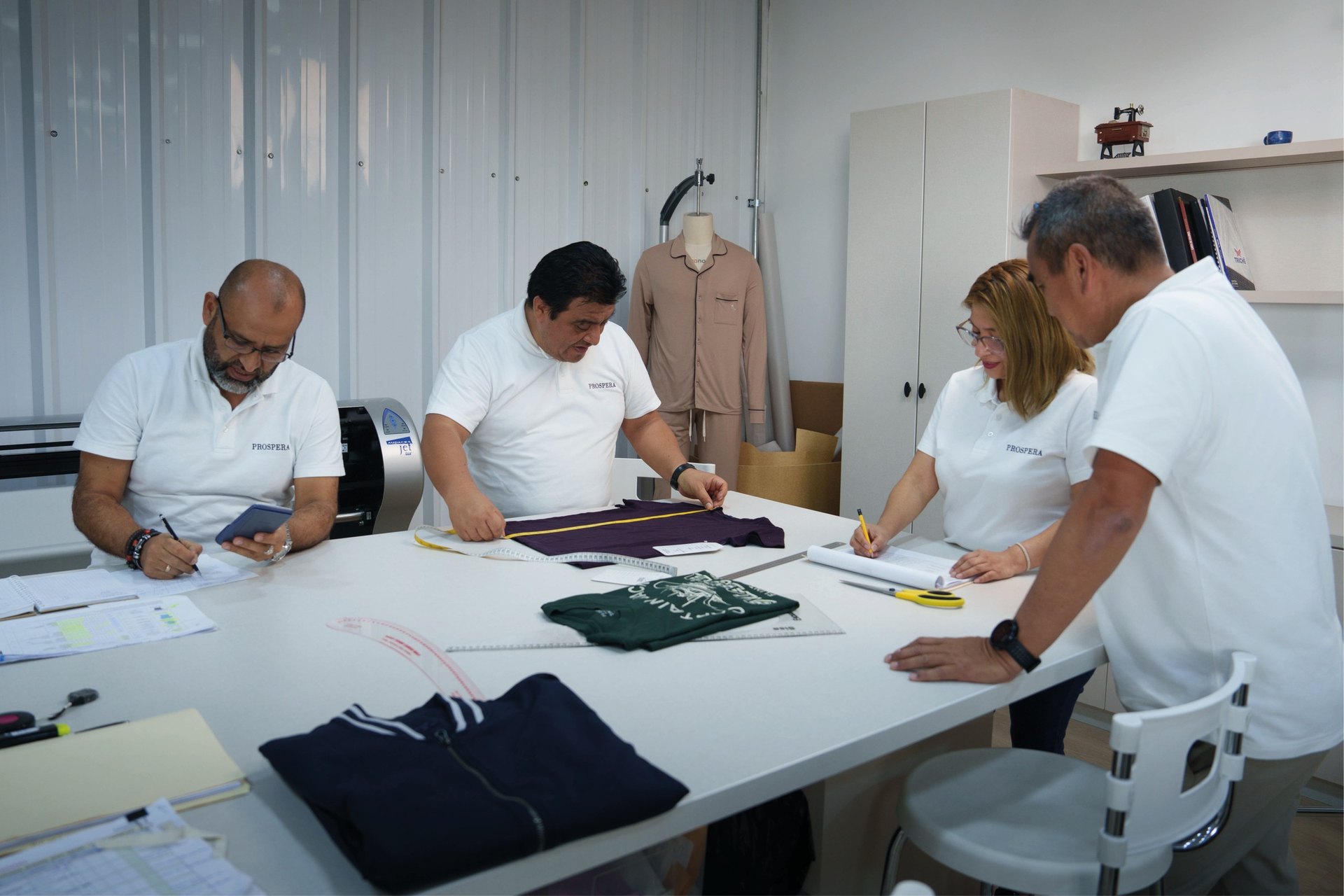 Prospera product development team reviewing garment samples together